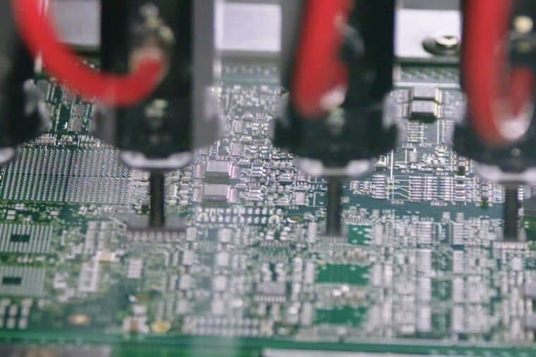 Automated pick-and-place heads assembling a circuit board