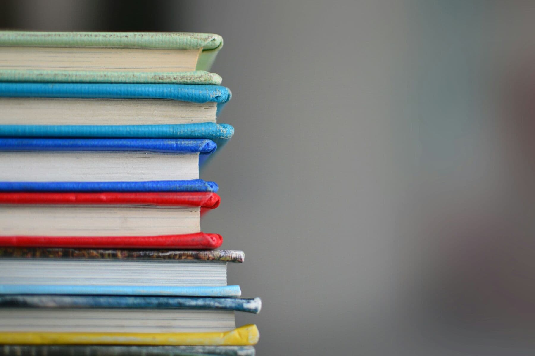 A stack of cloth-bound books seen from the side