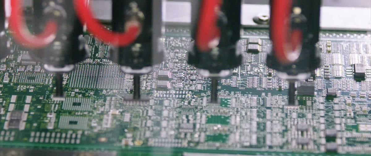 Automated pick-and-place heads assembling a circuit board